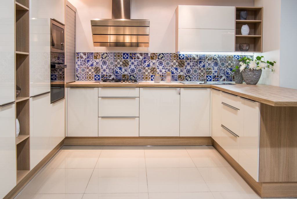 Finished kitchen renovation in Gretna with white cabinets and a tiled backsplash