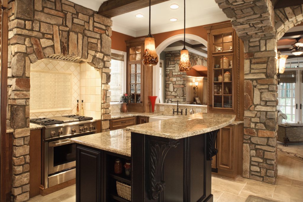 Traditional kitchen with a dark speckled granite island and cherry wood cabinets
