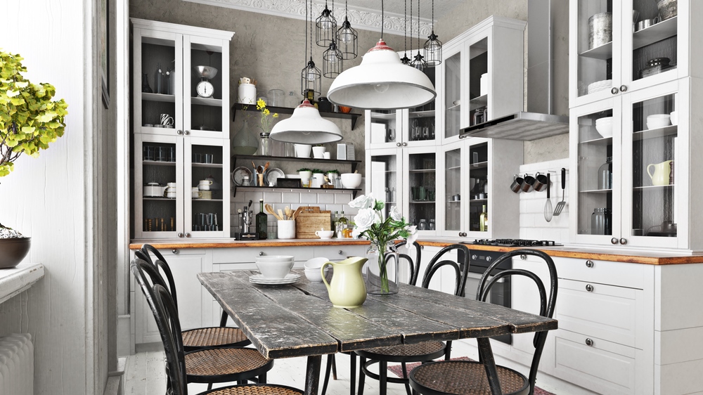 White country kitchen with a wood topped counter, open shelving and a dining table