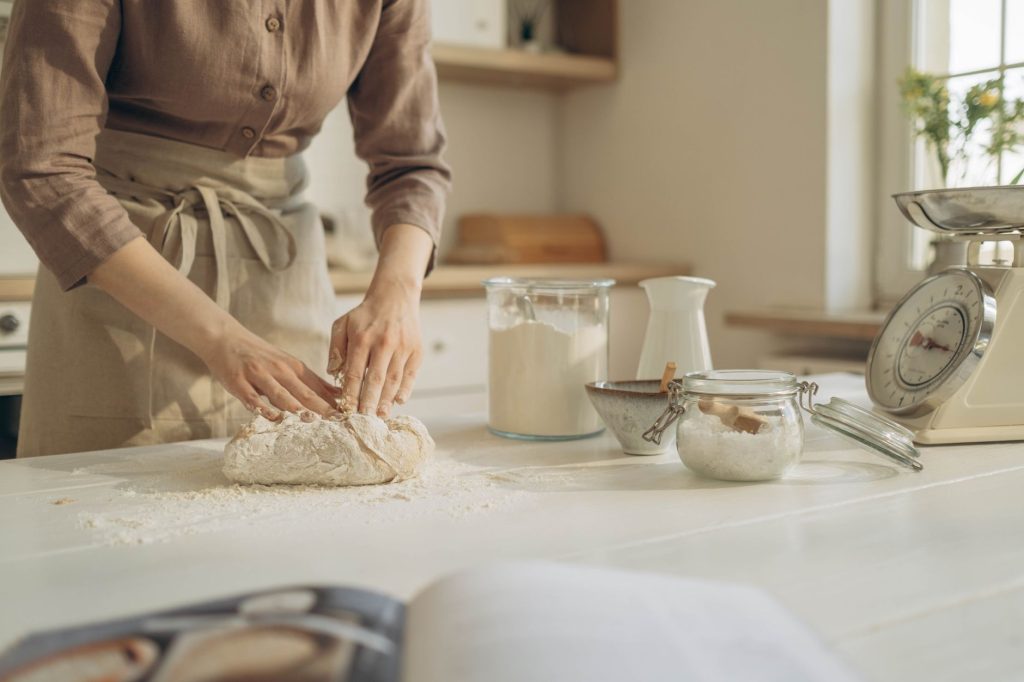 Hands kneading dough on a durable kitchen countertop