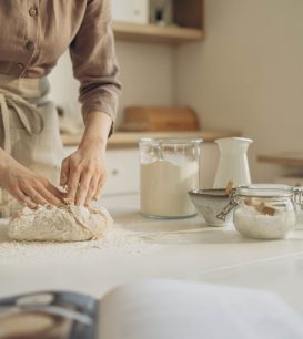 Baker kneading dough on a durable kitchen countertop