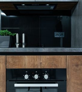 Modern kitchen design with wood cabinets and black accents
