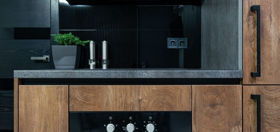Modern kitchen design with wood cabinets and black accents
