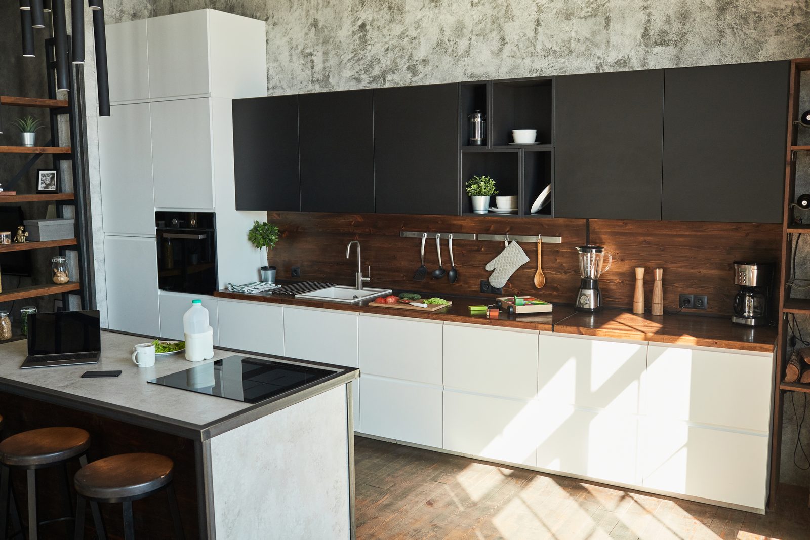 Modern kitchen with a long island, bar stools and a timber splashback
