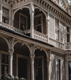 Raised Victorian home in New Orleans with a two-story gallery porch and front steps
