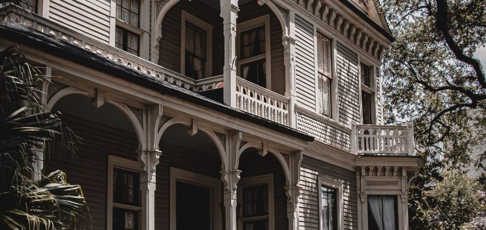 Raised Victorian home in New Orleans with a two-story gallery porch and front steps