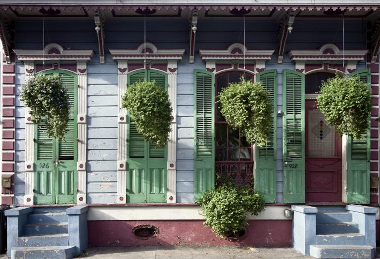 Front of a raised New Orleans house with steps up to the porch
