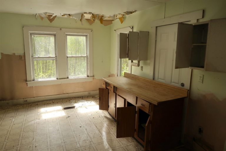 Dated kitchen with old cabinets and countertops before demolition