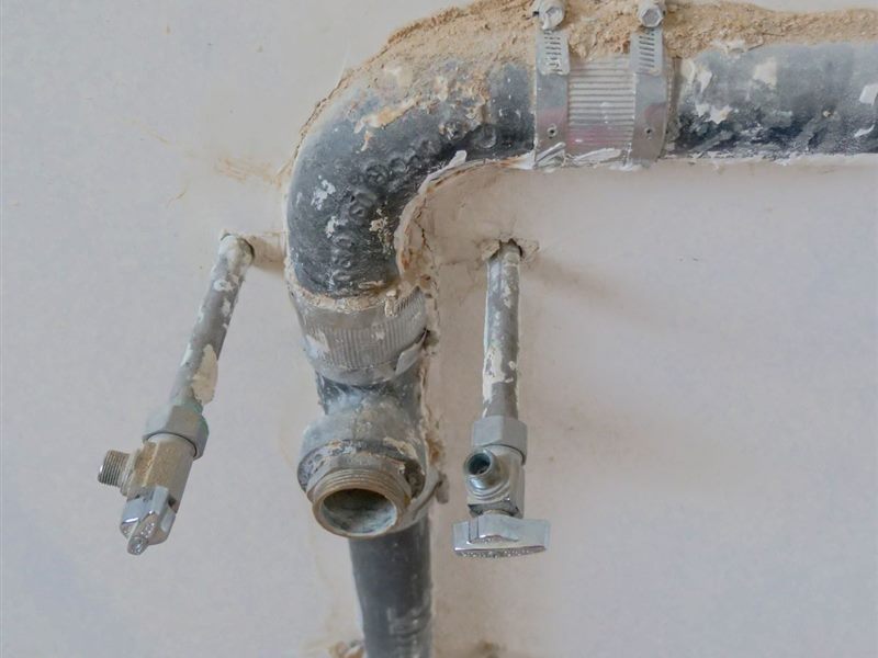 Exposed plumbing supply lines opened up during a remodel