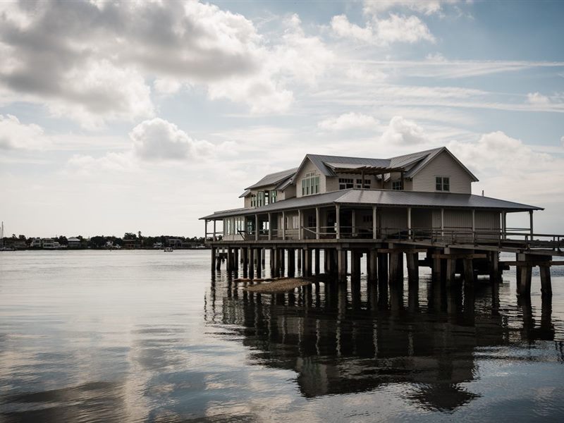 Raised house standing on pilings above open water